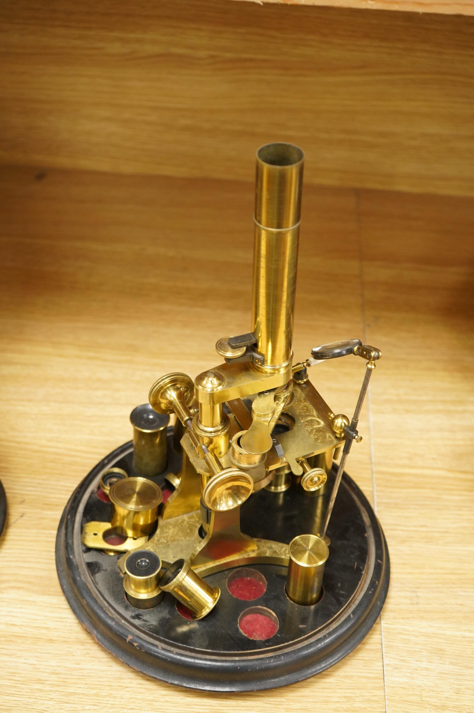 A mid 19th century brass monocular microscope, unsigned, with five objectives and three eyepieces, together with a Lieberkühn, a dark spot substage condenser, and a pair of Nicols prisms